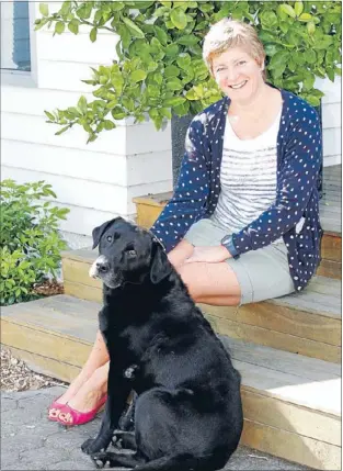  ?? Photo: DEREK FLYNN ?? Time-out: Blenheim winemaker Jules Taylor, with dog Sydney, juggles family life with keeping Jules Taylor Wines on the shelves worldwide. She was named New Zealand Producer of the Year for 2013.