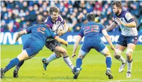  ?? Picture: SNS. ?? Former Howe of Fife star Peter Horne is challenged by France’s Guilhem Guirado.