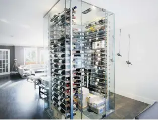  ??  ?? The best time to install a wine cellar — whether in the basement or as part of the living room — is during the constructi­on of a new property or renovation of an existing structure. Regardless of its size, the cellar requires special cooling units, walls (in this case, custom-made glass ones) and flooring.