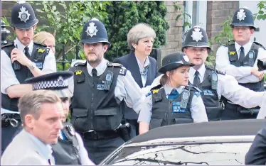  ?? Picture: RICHARD YOUNG/REX ?? GRENFELL AFTERMATH: Theresa May had to be protected by police as she left church