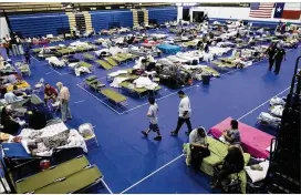  ?? STEPHEN SPILLMAN / FOR AMERICAN-STATESMAN ?? Hurricane Harvey evacuees continue to shelter at the Delco Center in East Austin on Tuesday. City officials don’t know yet how much it will cost to house evacuees, but they expect to be reimbursed by the state.