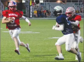  ?? ?? Quarterbac­k Marshall Shepherd, of Shelby, gets a block from a teammate and scrambles for additional yardage during the NCOFCA all-star game Friday evening. (Photo by Nick Woodlock