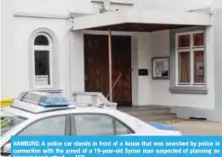  ??  ?? HAMBURG: A police car stands in front of a house that was searched by police in connection with the arrest of a 19-year-old Syrian man suspected of planning an Islamist bomb attack.—