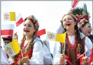  ?? AP/ALIK KEPLICZ ?? A group of folk dancers rehearses Wednesday prior to the arrival of Pope Francis at the military airport in Krakow, Poland.