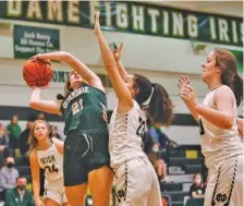  ?? STAFF PHOTO BY TROY STOLT ?? Silverdale’s Claire Bolton (21) shoots the ball as Notre Dame players defend on Tuesday.