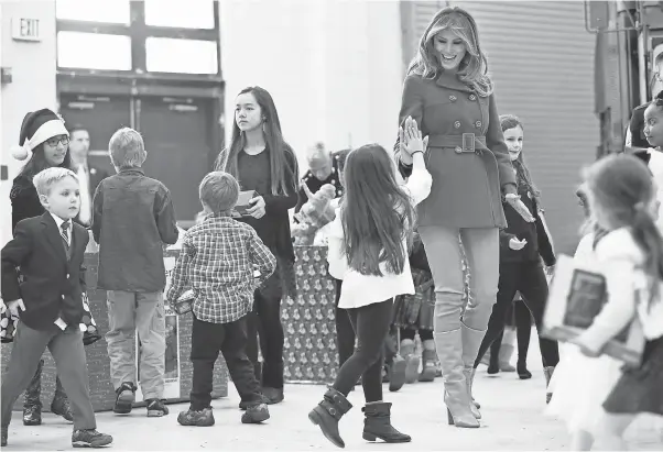  ?? JACQUELYN MARTIN/AP ?? Melania Trump greets the daughter of a military family last month at a Toys for Tots event at Joint Base Anacostia-Bolling in Washington, D.C.