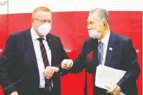  ?? RODRIGO REYES MARIN/ POOL/AFP VIA GETTY IMAGES ?? IOC VP John Coates and Yoshiro Mori, president of Tokyo 2020, bump elbows after a news conference for the Olympic and Paralympic Games in Tokyo Wednesday.