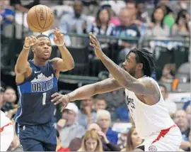  ?? LM Otero Associated Press ?? MAVERICKS GUARD Dennis Smith Jr. passes while being guarded by Clippers center DeAndre Jordan. The Clippers fell behind by as many as 33 points.