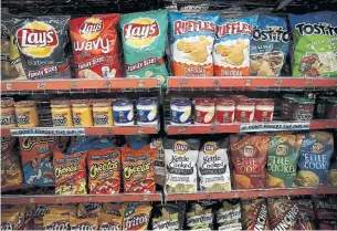  ?? JUSTIN SULLIVAN GETTY IMAGES FILE PHOTO ?? As COVID-19 raged across the U.S., consumers filled their shelves with salty, crunchy treats, driving double-digit sales growth for brands like Tostitos, Fritos and Cheetos.