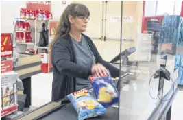  ?? RYAN TAPLIN/SALTWIRE NETWORK ?? Kim Gamble, a front-end supervisor with Atlantic Superstore scans groceries behind plexiglass at the store on Joseph Howe Drive in Halifax on Monday.