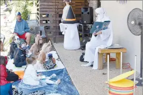  ?? File photo ?? “Granny Boo” (right) reads a Halloween story to children during “Treat Street” at the Bella Vista Public Library in 2021. “Treat Street” was one of many programs for children provided at the library, which is now offering several new programs.