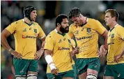  ??  ?? The two teams indulge in a touch of pushing and shoving, left, as the Wallabies, right, contemplat­e another defeat.