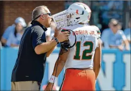  ?? GRANT HALVERSON / GETTY IMAGES 2017 ?? Coach Mark Richt, with quarterbac­k Malik Rosier at a game in October, says the incumbent starter “threw the ball pretty well” in spring practices.