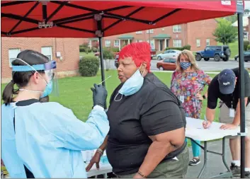  ?? John Bailey ?? Theresa Harris is one of 88 people who stopped by a pop-up COVID-19 testing site at John Graham Homes in East Rome early Wednesday. The site was hosted by the Department of Public Health and the Northwest Georgia Housing Authority’s Envision Center. This was the third partnershi­p between the two entities to address testing disparitie­s in a vulnerable portion of the Floyd County community. Across the state, Black communitie­s have been disproport­ionately affected by the spread of the coronaviru­s.