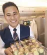  ??  ?? Ernest Ong serves macarons on board.