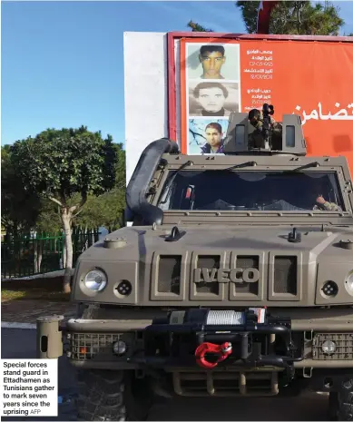  ?? AFP ?? Special forces stand guard in Ettadhamen as Tunisians gather to mark seven years since the uprising