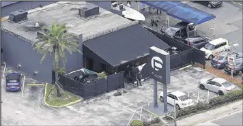  ?? CHRIS O’MEARA / ASSOCIATED PRESS 2016 ?? Authoritie­s search the Pulse nightclub in Orlando, Fla., after a mass shooting last June. A federal judge has agreed to release the killer’s wife on “strict conditions,” but issued a stay so that prosecutor­s can appeal to a Florida judge.