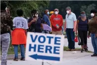  ?? Atlanta Journal-Constituti­on via AP ?? People wait in line to vote Monday in Decatur, Ga.