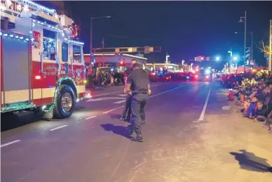  ?? ROBERTO E. ROSALES/JOURNAL ?? Firefighte­rs Eric Adair and Christophe­r Epley jumped into action and helped a young girl who was choking on a candy cane during the Twinkle Light Parade earlier this month. Adair and Epley got hero medals from the mayor on Tuesday.