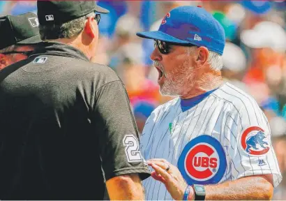  ?? | GETTY IMAGES ?? Joe Maddon argues with umpire Jerry Layne after Jake Arrietawas ruled to have hit Charlie Blackmon in the fifth.