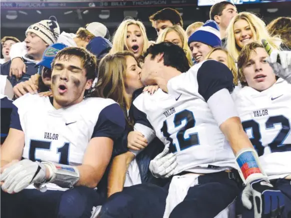  ?? Joe Amon, The Denver Post ?? Valor Christian QB Dylan McCaffrey (12) gets something extra as his team celebrates its Class 5A state championsh­ip win over Pomona on Saturday.