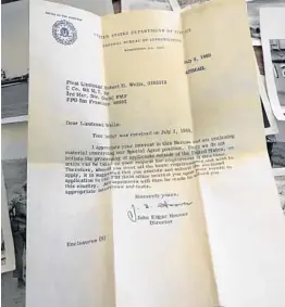  ?? AMY BETH BENNETT/SUN SENTINEL ?? A letter signed by J. Edgar Hoover was in an envelope containing old photos from a Marine’s military travels. The envelope was stashed in the ceiling above the kitchen of a Lighthouse Point home for 25 years, left behind by Robert Wells, now of Delray Beach.