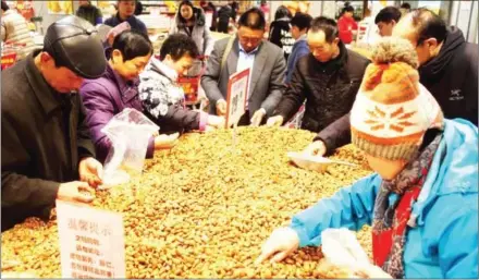  ?? CHEN SANHU/CHINA DAILY ?? People buy nuts at a supermarke­t in Hefei, Anhui province.