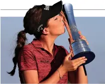  ??  ?? GEORGIA HALL of Great Britain poses with her trophy after winning the 2018 Women’s British Open Golf Championsh­ips at Royal Lytham &amp; St. Annes Golf Club, north west England on Aug. 5.