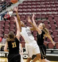  ?? Bud Sullins/Special to Siloam Sunday ?? Siloam Springs junior Jael Harried takes a shot while Prairie Grove defenders Kaylee Elder, left, and Emily Grant defending during Thursday’s game in the Siloam Springs Holiday Classic. The Lady Panthers defeated the Lady Tigers 44-29.