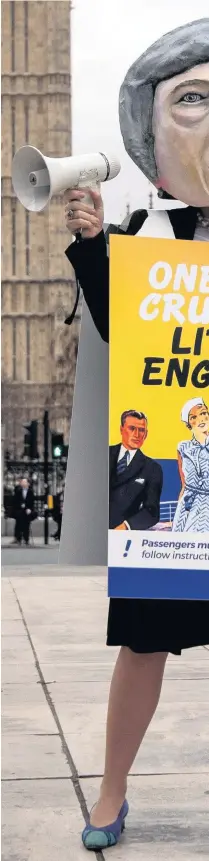  ??  ?? &gt; A pro-EU protester dressed as Theresa May takes part in a demonstrat­ion near Parliament yesterday