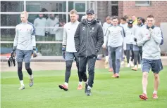  ?? - AFP photo ?? Liverpool’s German manager Jurgen Klopp (C) arrives with his players to take part in a team training session at Melwood in Liverpool, north west England on the eve of their UEFA Champions League quarter final second leg football match against FC Porto.