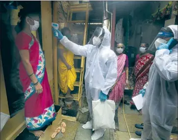  ?? Rafiq Maqbool Associated Press ?? A HEALTH WORKER takes a woman’s temperatur­e in Mumbai, India. Prime Minister Narendra Modi said the country must focus on bolstering the economy as it exits lockdowns, even as cases continued to increase.