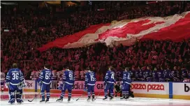  ?? FRANK GUNN / ASSOCIATED PRESS ?? Fans and players stand for the national anthems before Game 2 of a Stanley Cup playoffs first-round series between the Tampa Bay Lightning and the Toronto Maple Leafs on Wednesday in Toronto.