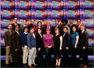  ?? JEOPARDY PRODUCTION­S ?? AP PHOTO BY This image released by Jeopardy Production­s, Inc. shows, front row from left, Brad Rutter, Colby Burnett, Alan Lin, Seth Wilson, Larissa Kelly, Monica Thieu, Pam Mueller, Matt Jackson, Jennifer Giles and Ken Jennings, back row from left, Ben Ingram, Roger Craig, David Madden, Julia Collins, host Alex Trebek, Austin Rogers, Leonard Cooper, Alex Jacob and Buzzy Cohen on the set of the game show “Jeopardy!” The game show’s first-ever team tournament will pit groups of former champions against each other in 10 weekday episodes airing from Wednesday, Feb. 20, to Tuesday, March 5.