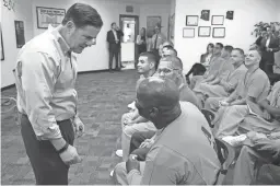  ??  ?? Gov. Doug Ducey speaks with inmate Marcus Moore in the Second Chance Center at the Lewis state prison complex in Buckeye.