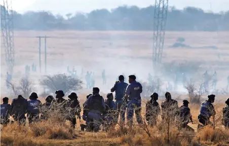  ?? PICTURE: REUTERS ?? JACK-BOOT RESPONSE: Police clash with striking workers at a mine near Rustenburg. The state has continued responding to dissent with apartheid-style tactics, instead of tackling the social-economic issues, writes the author.