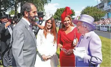  ?? T ?? Queen Elizabeth II congratula­tes Shaikh Mohammad, Princess Haya and their daughter Shaikha Al Jalila after Masar won the Epsom Derby on Saturday.