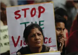  ?? RAJESH KUMAR SINGH — THE ASSOCIATED PRESS ?? Activists from different organizati­ons hold banners calling for peace and communal harmony following violence in New Delhi, India on Wednesday.