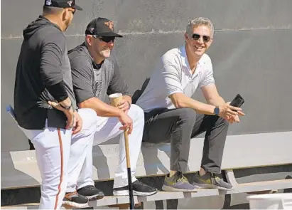  ?? LLOYD FOX/BALTIMORE SUN ?? Orioles manager Brandon Hyde, center, and GM Mike Elias, right, are working to have their team ready whenever the season starts.