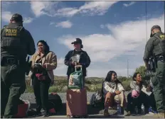  ?? MARK ABRAMSON — THE NEW YORK TIMES ?? Border Patrol agents take into a custody a group of migrants for processing in Jacumba, along the California border, this week.