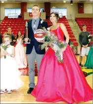  ??  ?? This magic moment…Farmington seniors Javan Jowers and Bailee King reigned as king and queen of the Cardinal 2018 Colors Day festivitie­s held at Cardinal Arena Friday. Ava Berger (left) carried the crown and couldn’t resist stealing one more moment in...