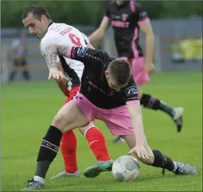  ??  ?? Gary Delaney of Wexford Youths is tackled by Christy Fagan .