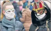  ?? REUTERS ?? ■
Revellers wear protective masks at Venice. Officials cancelled the last two days of the Venice Carnival due to the virus.