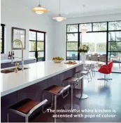  ??  ?? The minimalist white kitchen is accented with pops of colour