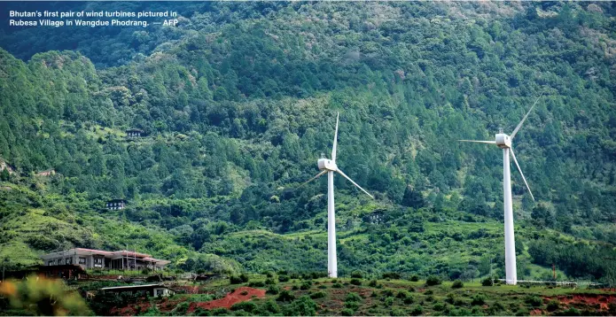  ??  ?? Bhutan’s first pair of wind turbines pictured in Rubesa Village in Wangdue Phodrang. — AFP