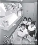  ??  ?? Pupils read books at a reading corner.