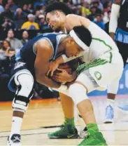  ?? Thearon W. Henderson, Getty Images ?? Oregon’s Dillon Brooks, right, and Rhode Island’s E.C. Matthews battle for the ball Sunday.