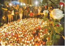  ?? AP-Yonhap ?? People place candles as they mourn the mayor of Gdansk, Pawel Adamowicz in Gdansk, Poland, Monday. The popular liberal mayor of the Polish port city of Gdansk died from stabbing wounds during a charity event the previous evening by an ex-convict who stormed onstage.