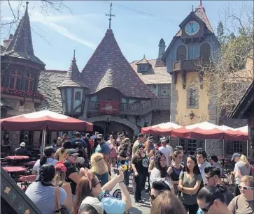  ?? Photograph­s by Todd Martens Los Angeles Times ?? THE CUP CROWD was out in force Friday at Disneyland in hopes of acquiring “Beauty and the Beast” cups.