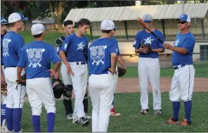  ?? NEWS-SENTINEL PHOTOS BY MIKE BUSH ?? Above: Lodi 14U baseball manager Ralph Bain, right, instructs his players at the start of Tuesday's practice at Kofu Park. Below: Lodi 14U pitcher Nate Bettencour­t warms up.